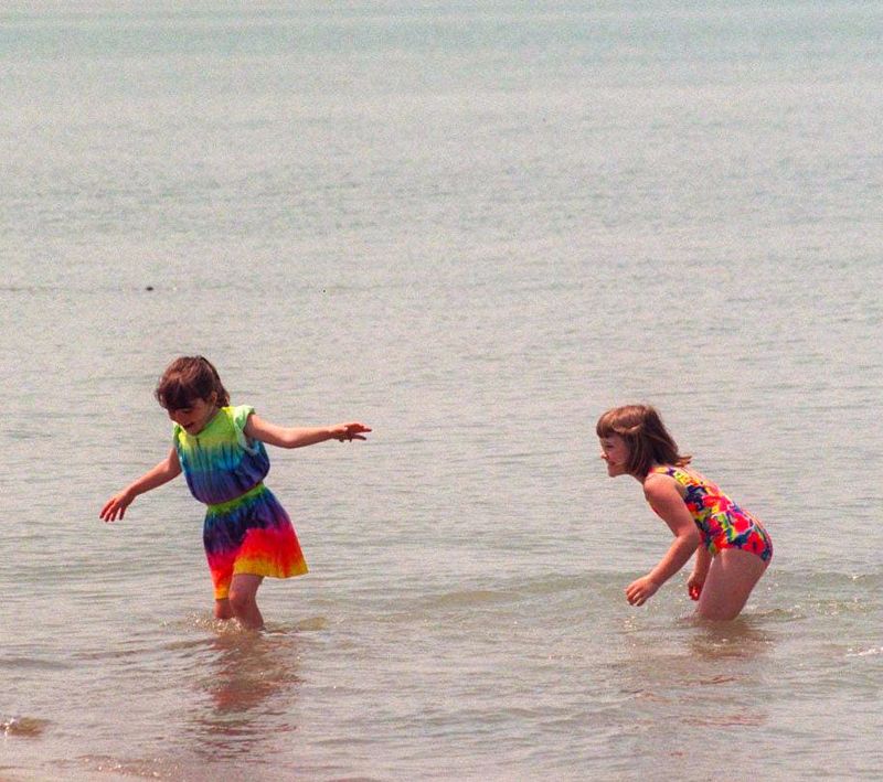 From left, Francesca Spagnolo, 7, and Alisha Bernecker, 8, splash around in the water at Belle Isle beach on June 12, 1996. It was their first time at the beach.