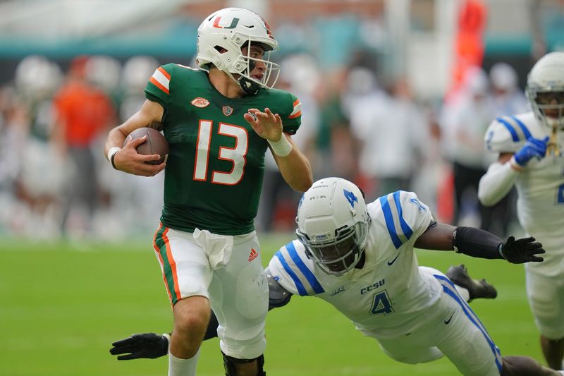 Sep 25, 2021; Miami Gardens, Florida, USA; Central Connecticut State Blue Devils outside linebacker Luquay Washington (4) attempts to tackle Miami Hurricanes quarterback Jake Garcia (13) during the first half at Hard Rock Stadium. Mandatory Credit: Jasen Vinlove-USA TODAY Sports