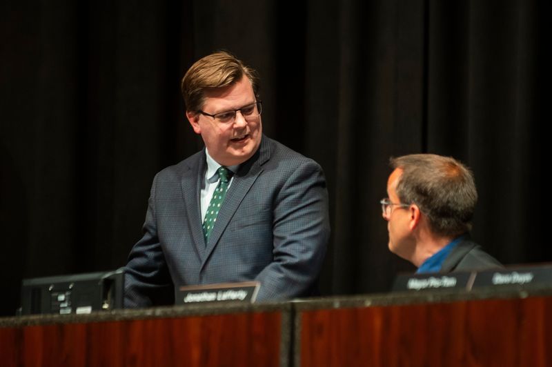 Warren City Council attorney Jeffrey Schroder, left, speaks with Warren City Council member Jonathan Lafferty, right, during a special meeting of the council on Thursday, July 25, 2024.