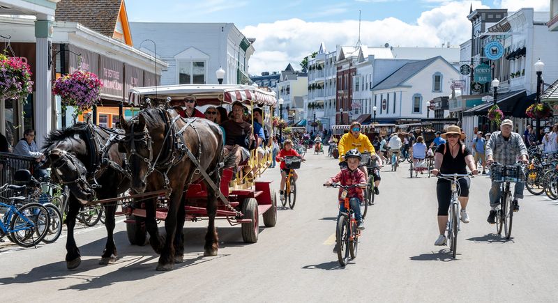 Bikes and carriages share Main Street on Mackinac Island, Wednesday, June 26, 2024.