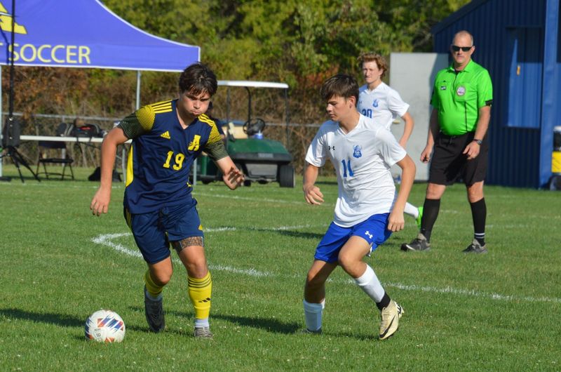 Nolan Sanders (left) handles the ball for Airport during an 8-0 victory over Dundee on Friday, Aug. 16, 2024.