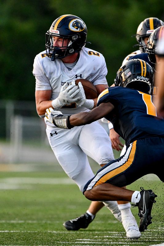 DeWitt's Traverse Moore runs for a gain against Haslett during the first quarter on Thursday, Aug. 29, 2024, at Haslett High School.