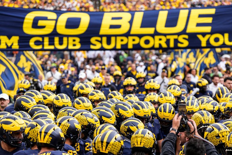 Michigan players huddle before kickoff against Texas at Michigan Stadium in Ann Arbor on Saturday, September 7, 2024.