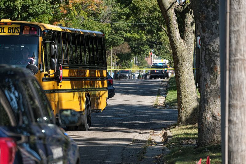 A school bus pulls away from the scene of a shooting near Riddle Elementary School in Lansing Tuesday, Sept. 17, 2024.