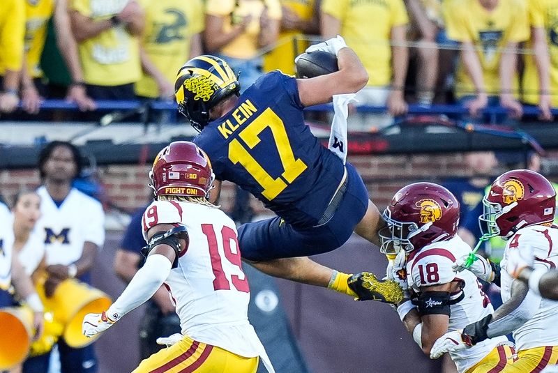 Michigan tight end Marlin Klein (17) tries to jump over USC cornerback John Humphrey (19) during the second half at Michigan Stadium in Ann Arbor on Saturday, Sept. 21, 2024.