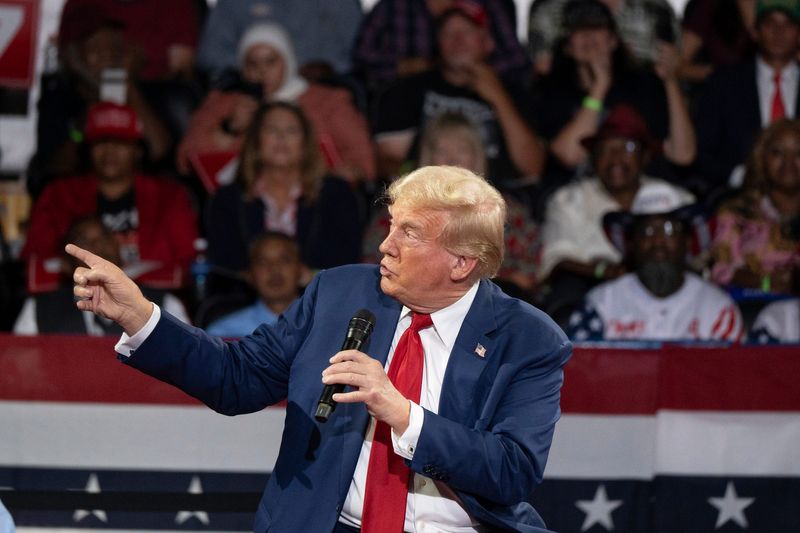 Former president Donald Trump talks about the assassination attempt on him as he speaks to an audience during a town hall meeting at Dort Financial Center in Flint, Michigan on Tuesday, September 17, 2024.