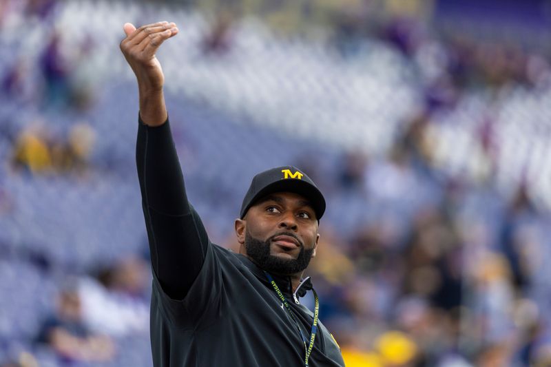 Michigan Wolverines head coach Sherrone Moore walks out of the locker room during pregame warmups against the Washington Huskies at Alaska Airlines Field at Husky Stadium, Oct. 5, 2024 in Seattle.