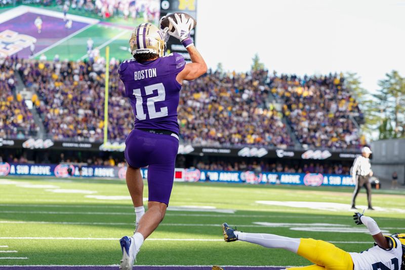 Washington Huskies wide receiver Denzel Boston catches a touchdown pass against the Michigan Wolverines during the first quarter at Alaska Airlines Field at Husky Stadium, Oct. 5, 2024 in Seattle.