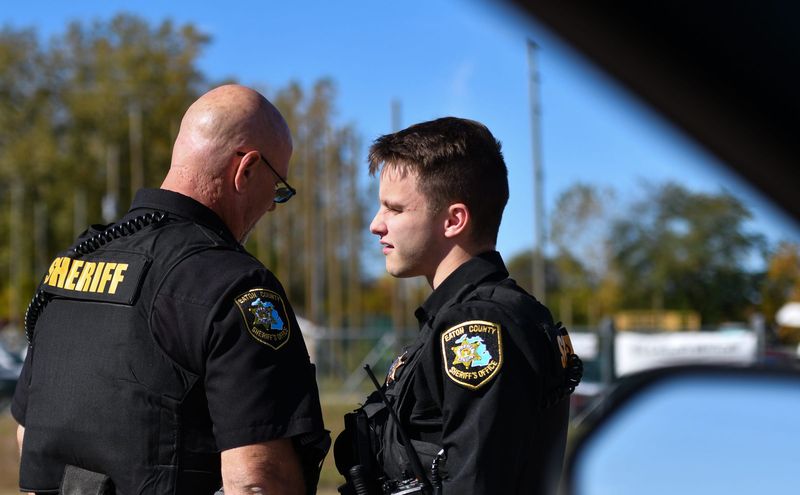 Eaton County Deputy Kevin Shaltry, right, and deputy John Davidson talk after responding to a call in Delta Township, Tuesday Oct. 8, 2024.