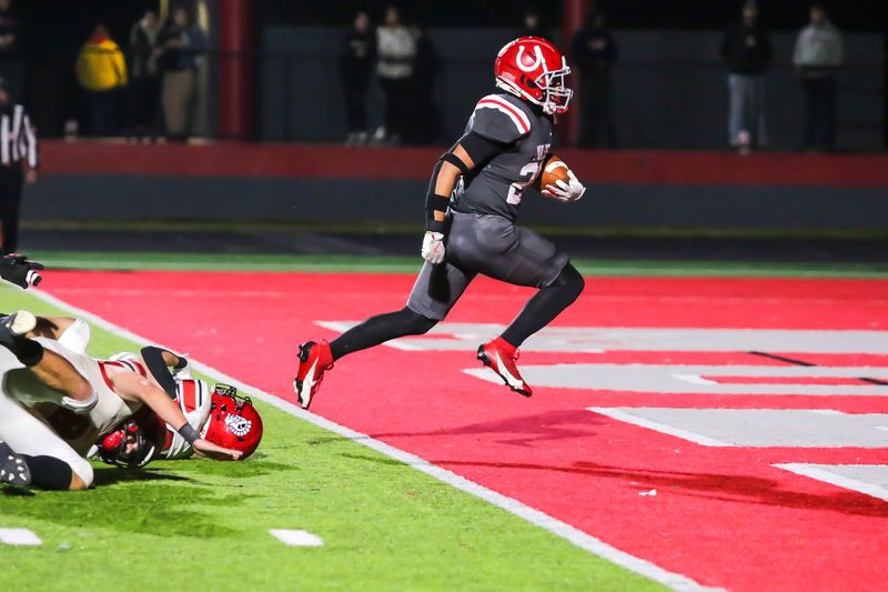 Trenton Smithson scores a touchdown against Monroe during a 33-0 Bedford victory on Friday, Oct. 18, 2024.