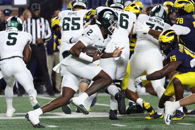 Oct 26, 2024; Ann Arbor, Michigan, USA; Michigan State Spartans quarterback Aidan Chiles (2) rushes in the first half against the Michigan Wolverines at Michigan Stadium. Mandatory Credit: Rick Osentoski-Imagn Images