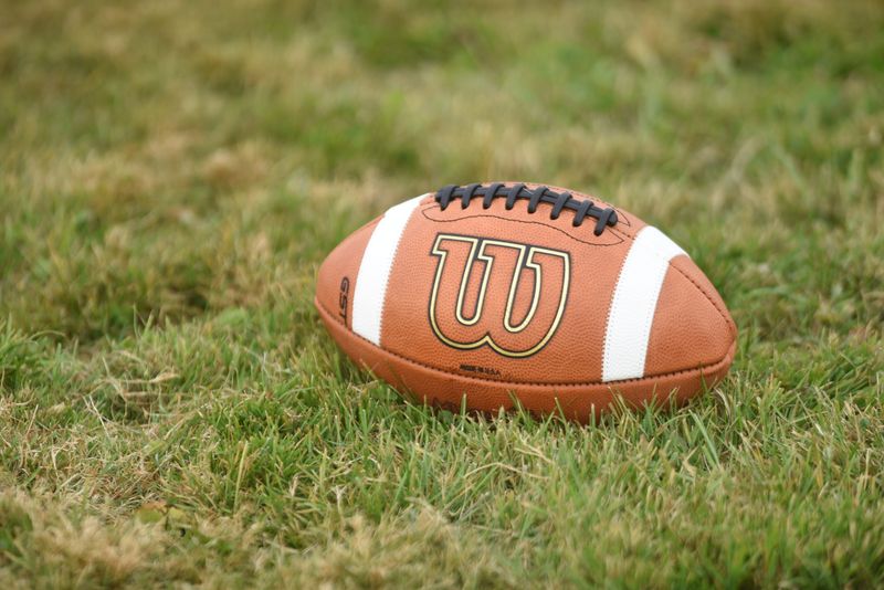 A football sits on the grass during a practice at Marine City High School in Marine City on Wednesday, Oct. 30, 2024.