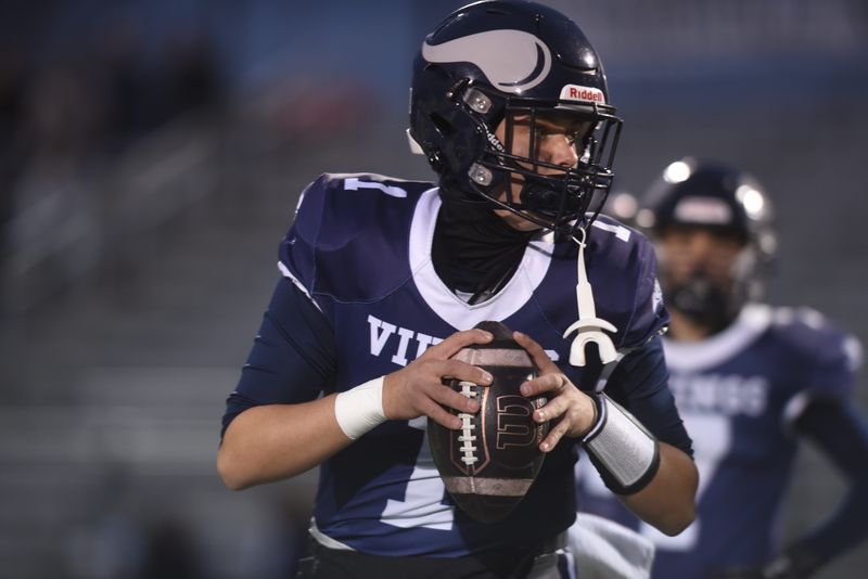 Marysville's Brady Wright drops back to pass before a game last season.