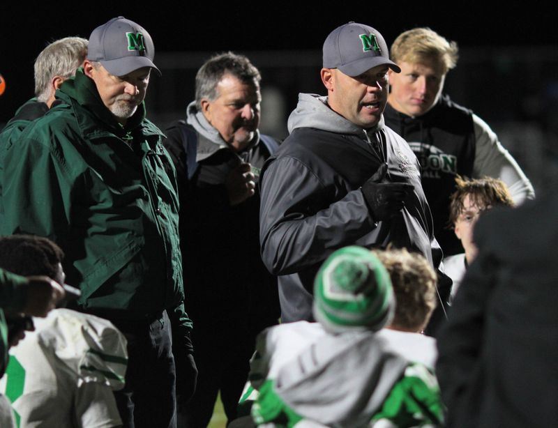 The Mendon coaching staff talks to the team following a victory over Climax-Scotts in the playoffs last season.