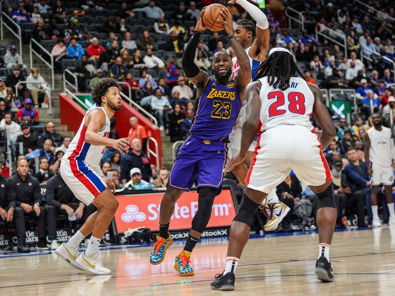 Los Angeles Lakers forward LeBron James (23) drives hard to the basket, while be triple-teamed by Detroit Pistons guard Cade Cunningham (2), guard Jaden Ivey (23) and center Isaiah Stewart (28) during the second half at Little Caesars Arena in Detroit on Monday, Nov. 4, 2024. The Pistons won 115-103.
