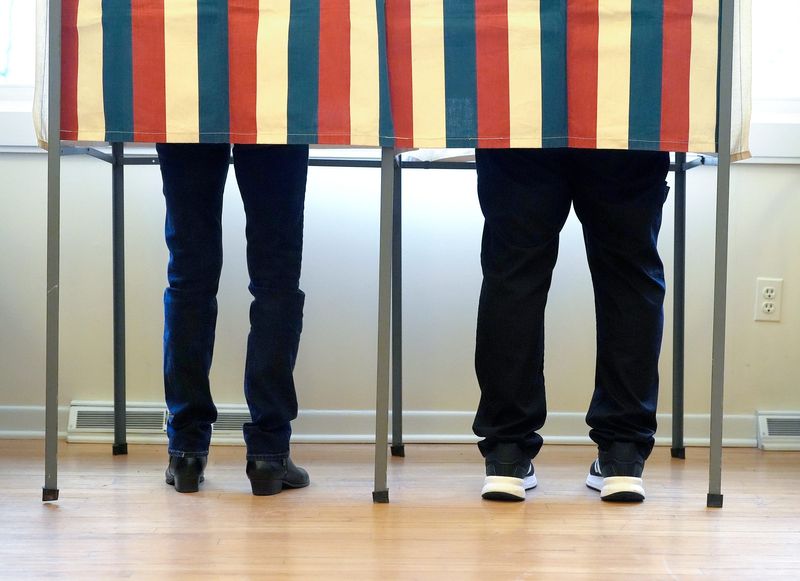 Voters from Lake Angelus, Michigan, in Oakland County, cast their votes behind curtains inside of an old one room school house in precinct one on Election Day, Tuesday, Nov. 5, 2024.
The small town near Auburn Hills has between 300 and 320 voters.