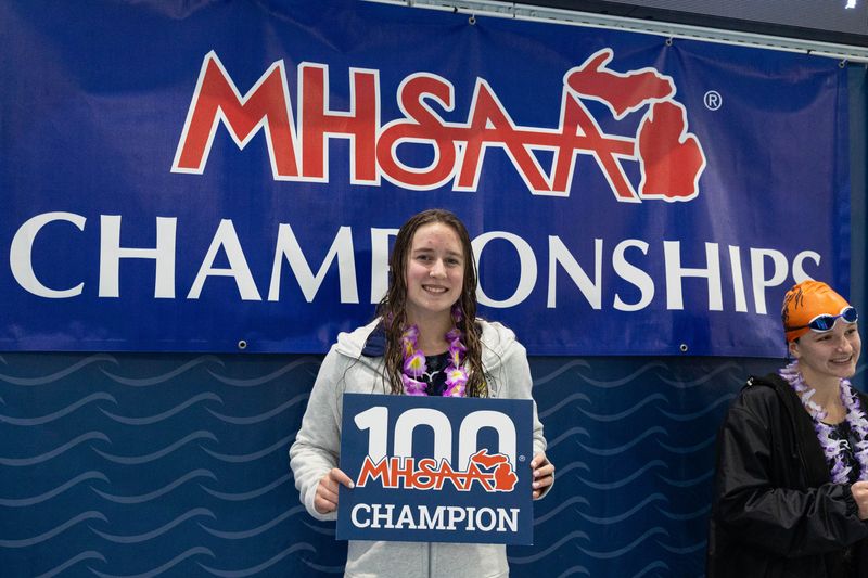 Zeeland's Madison Ensing smiles after finishing first in the 100 yard backstroke at the Swimming State Finals on Saturday, Nov. 23 at Holland Aquatic Center.
