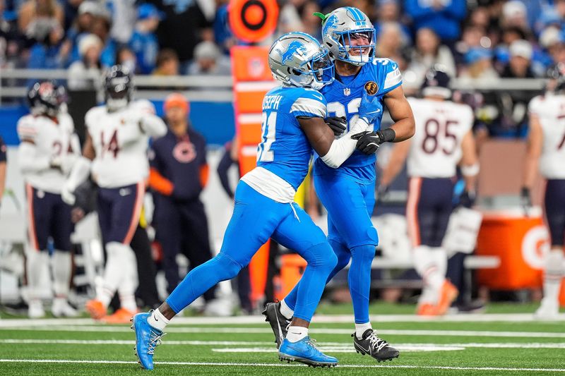 Detroit Lions safety Kerby Joseph (31), left, and safety Brian Branch (32) celebrate a play against Chicago Bears during the first half at Ford Field in Detroit on Thursday, Nov. 28, 2024.