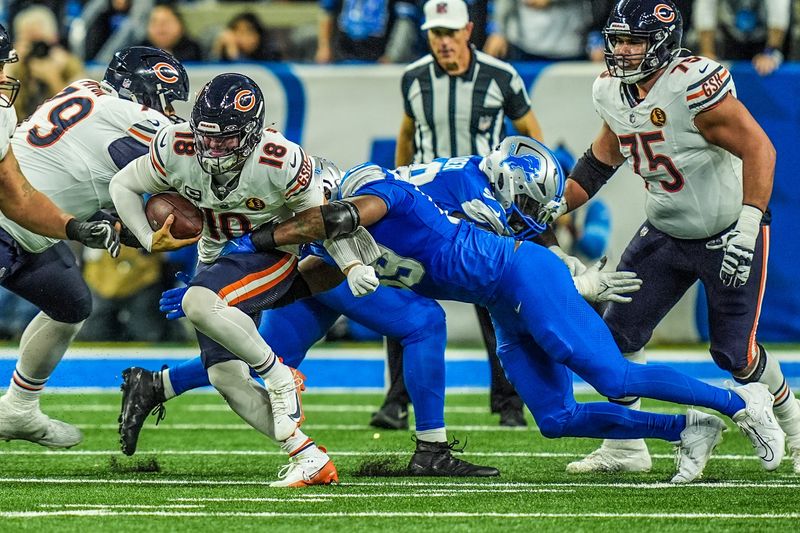 Chicago Bears quarterback Caleb Williams (18) is sacked by Detroit Lions defensive end Za'Darius Smith (99) in the fourth quarter on Thanksgiving Day at Ford Field in Detroit on Thursday, Nov. 28, 2024.