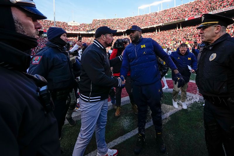 Ohio State Buckeyes head coach Ryan Day shakes hands with Michigan Wolverines head coach Sherrone Moore following the NCAA football game at Ohio Stadium in Columbus on Saturday, Nov. 30, 2024. Michigan won 13-10.