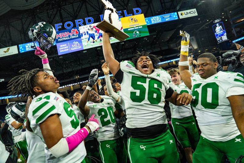 Detroit Cass Tech’s Antijuan Wilkes Jr., Marvin McCallum, Logan Howell, and Jestin Wilson celebrate their win against Hudsonville, at the end of the MHSAA Division 1 football finals at Ford Field in Detroit on Saturday, Nov. 30, 2024.