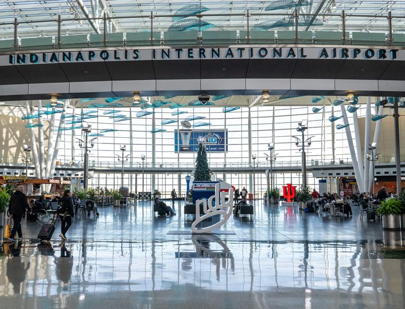 Travelers make their way to either terminal Monday, Dec. 2, 2024, inside Indianapolis International Airport.