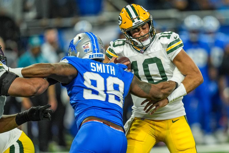 Green Bay Packers quarterback Jordan Love (10) is sacked by Detroit Lions defensive end Za'Darius Smith (99), during the Thursday Night Football at Ford Field in Detroit on Thursday, Dec. 5, 2024.