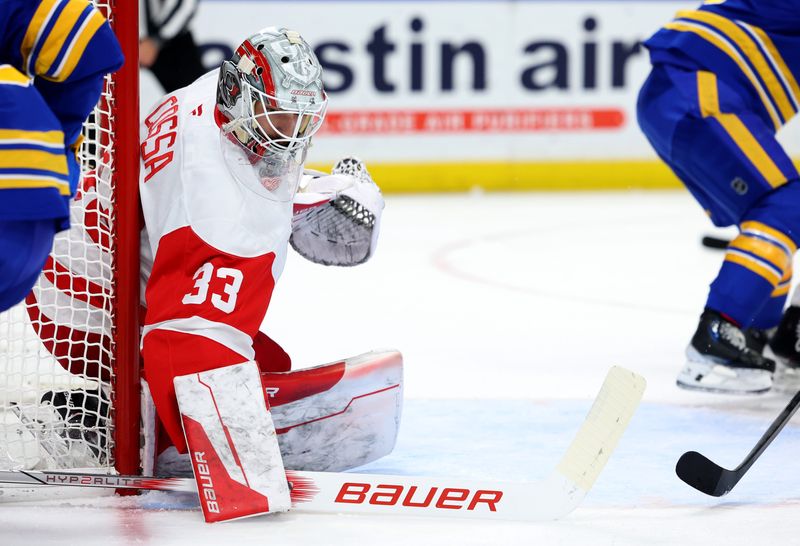 Detroit Red Wings goaltender Sebastian Cossa (33) looks for the puck during the second period against the Buffalo Sabres at KeyBank Center in Buffalo, New York, on Monday, Dec. 9, 2024.