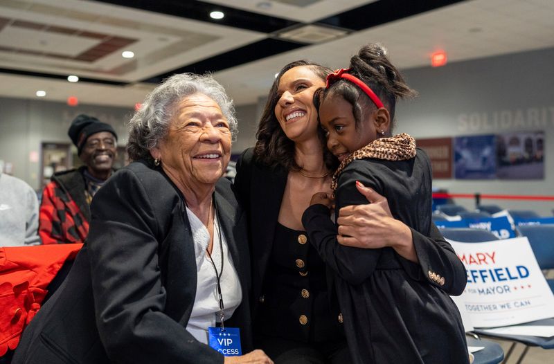 Detroit City Council President Mary Sheffield hugs her grandmother Mary Coty and her cousin Rylan Owens inside the IBEW Local Union 58 hall in Detroit on Tuesday, Dec. 10, 2024.