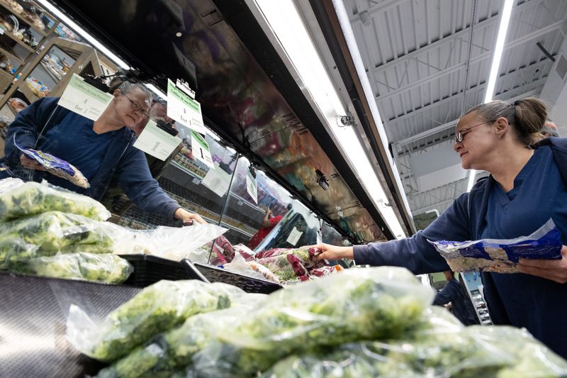 Rebecca Smedberg looks at the fresh produce section at the Community Action House Food Club on Tuesday, Nov. 5.