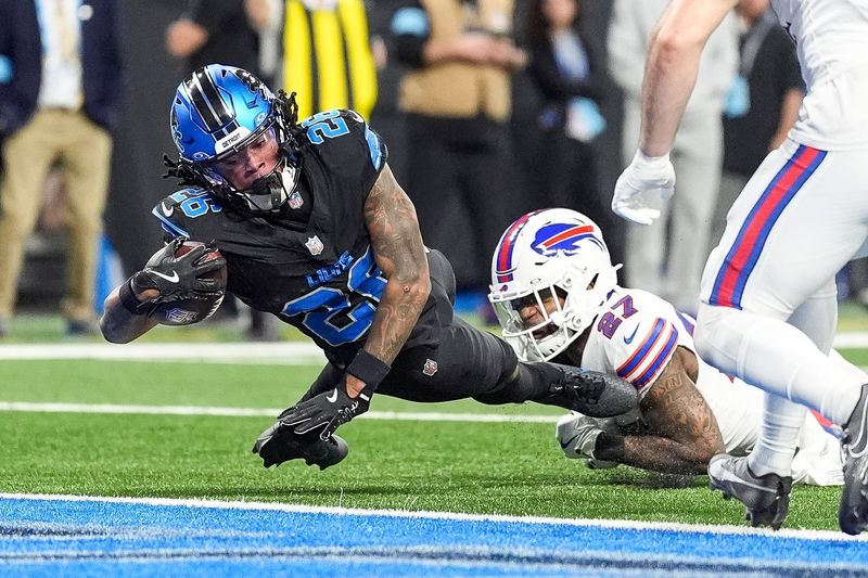 Detroit Lions running back Jahmyr Gibbs (26) runs for a touchdown against Buffalo Bills safety Kareem Jackson (27) during the second half at Ford Field in Detroit on Sunday, Dec. 15, 2024.