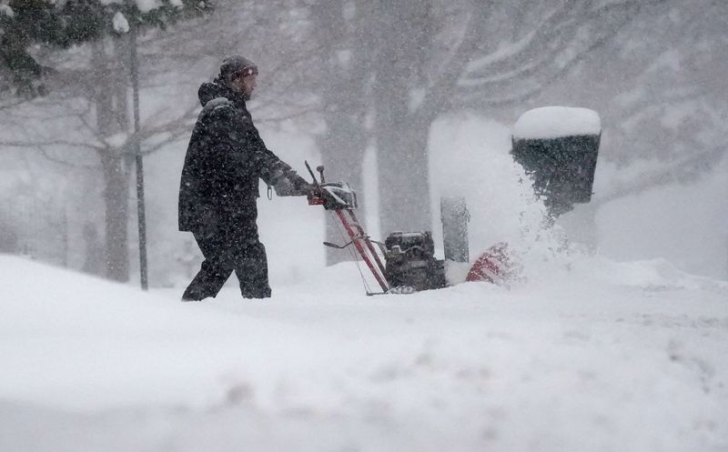 Austin Tiller, clears his driveway in Blue Ash, Monday, Jan. 6, 2025. The home health therapist was hoping he would be able to get out to see his patients. The region already has several inches of snow and is expected to get more, according to the weather service.