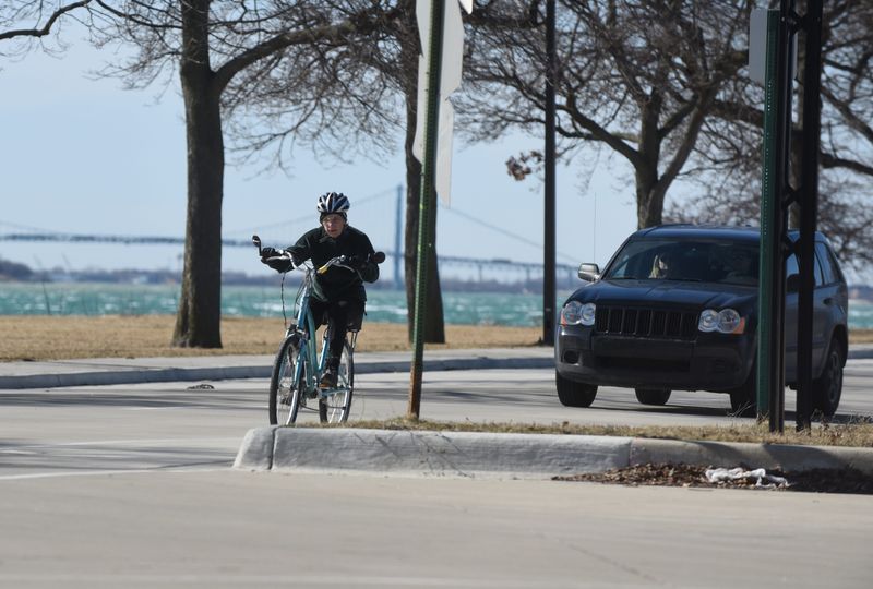Bike riders are seen on Saturday February 20, 2016 on Belle Isle as the Ambassador Bridge is seen in the background as record temperatures hit the Detroit area.