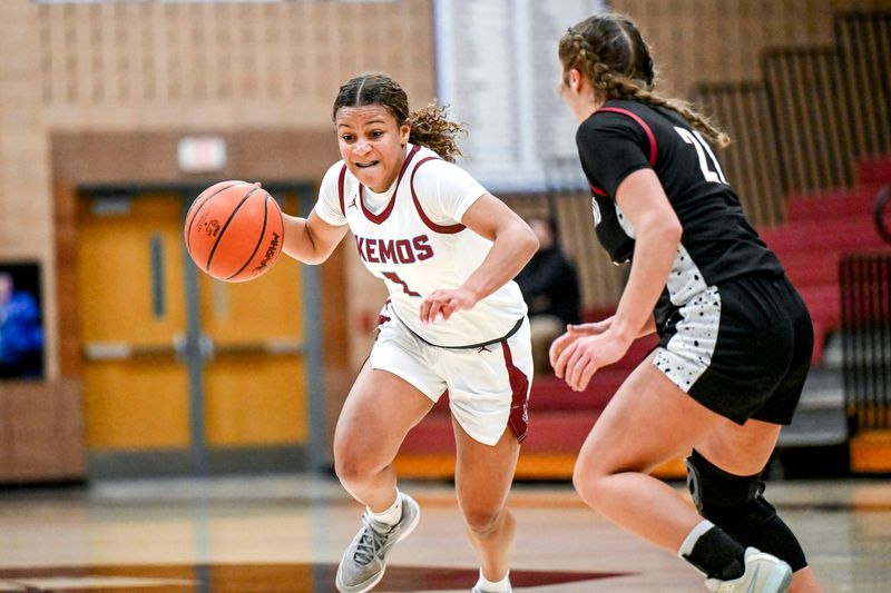 Okemos' Natalia Hawks, left, moves the ball against Portland's Summer Stopczynski during the second quarter on Thursday, Jan. 23, 2025, at Okemos High School.
