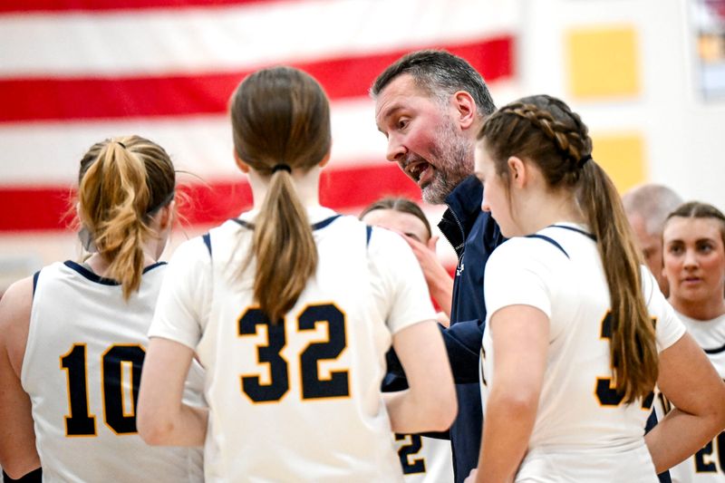 DeWitt's head coach Bill McCullen talks to the team during a timeout in the second quarter on Friday, Jan. 24, 2025, at DeWitt High School.