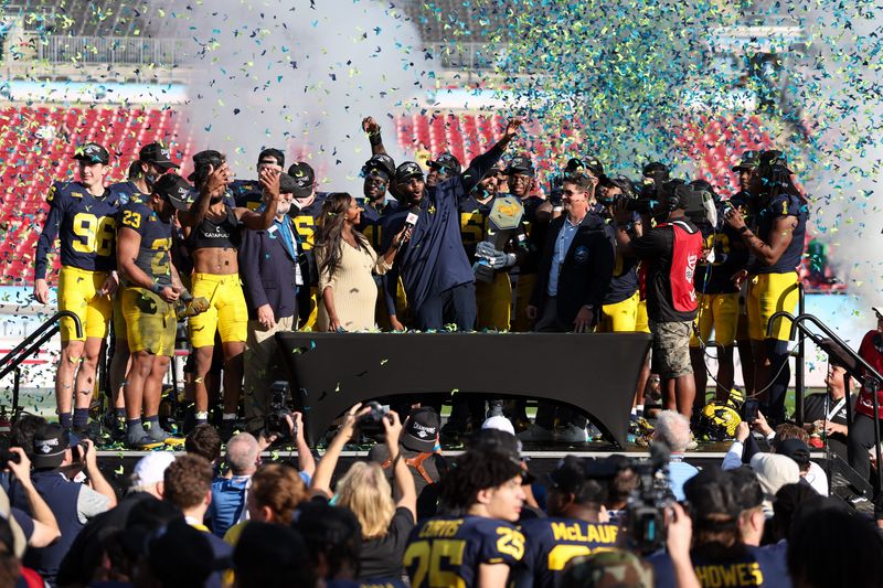 Dec 31, 2024; Tampa, FL, USA; Michigan Wolverines head coach Sherrone Moore celebrates after beating the Alabama Crimson Tide in the ReliaQuest Bowl at Raymond James Stadium. Mandatory Credit: Nathan Ray Seebeck-Imagn Images