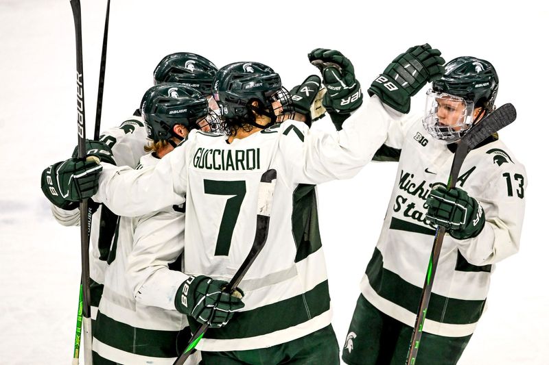Michigan State's Matt Basgall, left, celebrates his goal with teammates David Gucciardi, center, and Tiernan Shoudy during the first period in the game against Minnesota on Saturday, Jan. 25, 2025, at Munn Arena in East Lansing.