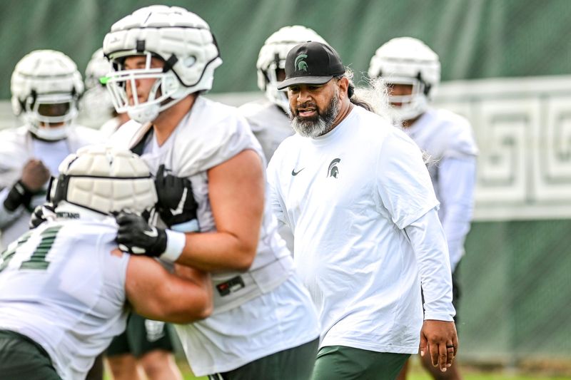 Michigan State's defensive line coach Legi Suiaunoa works with players during the first day of football camp on Tuesday, July 30, 2024, in East Lansing.