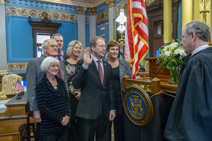 Michigan Sen. Dan Lauwers, R-Brockway Township, center, and his wife, Kellie Lauwers, right, participating in a swearing-in ceremony in Lansing in 2019.