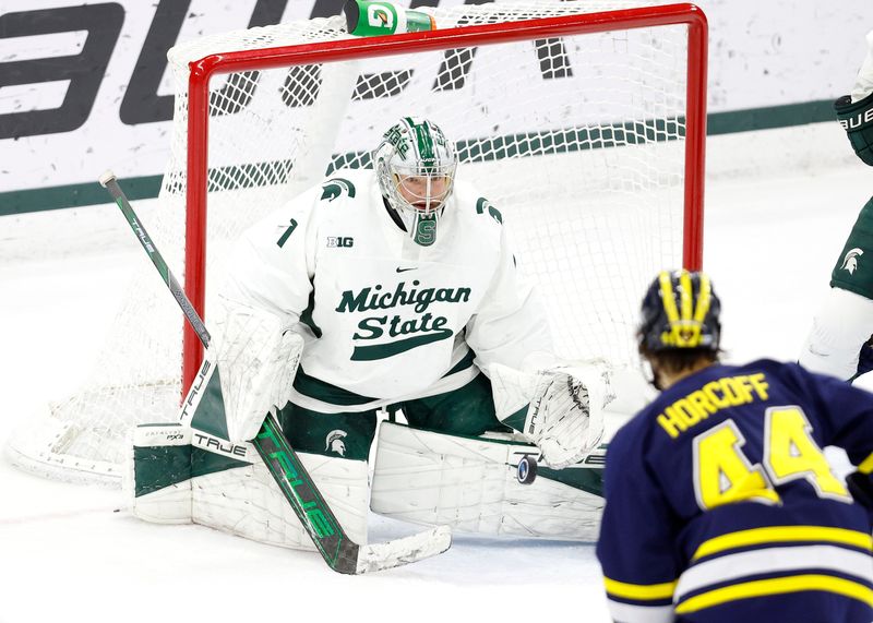 Michigan State goalkeeper Trey Augustine deflects a shot by Michigan's Will Horcoff (44), Friday, Feb. 7, 2025, in East Lansing.