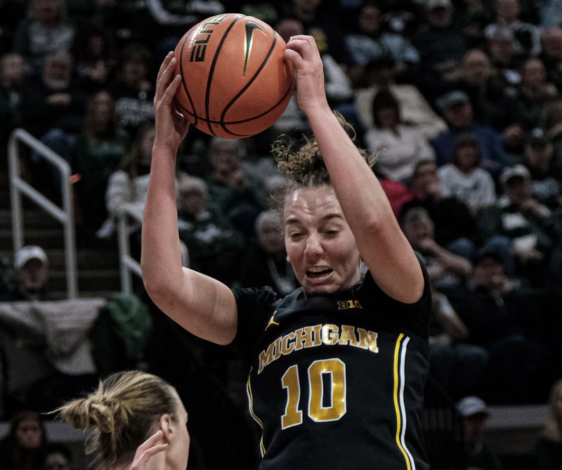 Michigan's Jordan Hobbs (10) pulls down a rebound against Michigan State at the Breslin Center Sunday, Feb. 9, 2025.