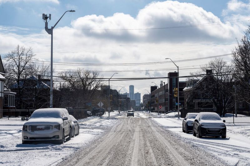 Snow covers dozens of cars and sidewalks in midtown Detroit on Thursday, Feb. 13, 2025.