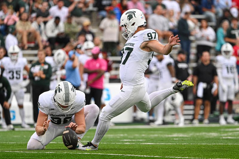 Sep 7, 2024; College Park, Maryland, USA; Michigan State Spartans place kicker Jonathan Kim (97) kicks a extra point during the first half against the Maryland Terrapins at SECU Stadium. Mandatory Credit: Tommy Gilligan-Imagn Images