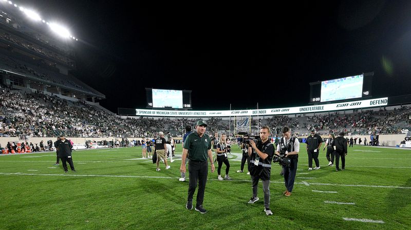 Aug 30, 2024; East Lansing, Michigan, USA; Michigan State Spartans head coach Jonathan Smith walks off the field after his team beat the Florida Atlantic Owls at Spartan Stadium. Mandatory Credit: Dale Young-USA TODAY Sports