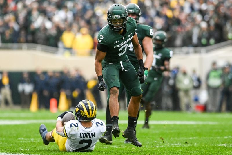 Michigan State's Xavier Henderson, right, celebrates after tackling Michigan's Blake Brad Hawkins during the fourth quarter on Saturday, Oct. 30, 2021, at Spartan Stadium in East Lansing.

211030 Msu Michigan 205a