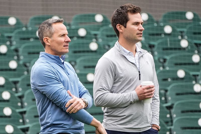 Detroit Tigers team owner Chris Ilitch, left, talks to president of baseball operation Scott Harris as they watch batting practice during spring training at Joker Marchant Stadium in Lakeland, Fla. on Thursday, Feb. 20, 2025.