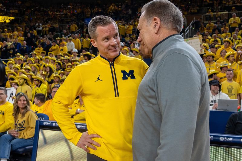 Michiganâ€™s Dusty May greets Michigan Stateâ€™s Tom Izzo before their rivalry matchup game at Crisler Center in Ann Arbor, on Friday, Feb. 21, 2025.
