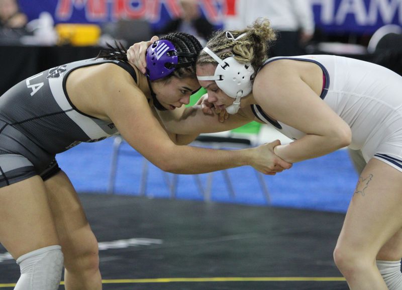 Le'anna Zavala (left) of Holland West Ottawa was fifth at 190 pounds in the MHSAA individual wrestling finals Saturday, March 1, 2025 at Ford Field.