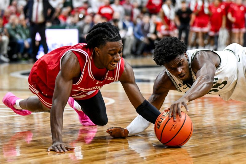 Michigan State's Coen Carr, right, and Wisconsin's John Blackwell go after the ball during the second half on Sunday, March 2, 2025, at the Breslin Center in East Lansing.