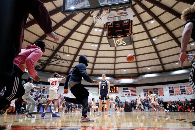 Players and fans react after Sexton's Keyshawn Summerville's game-winning three-quarter-court heave as time expired against Chelsea, Thursday, March 6, 2025, in Charlotte.